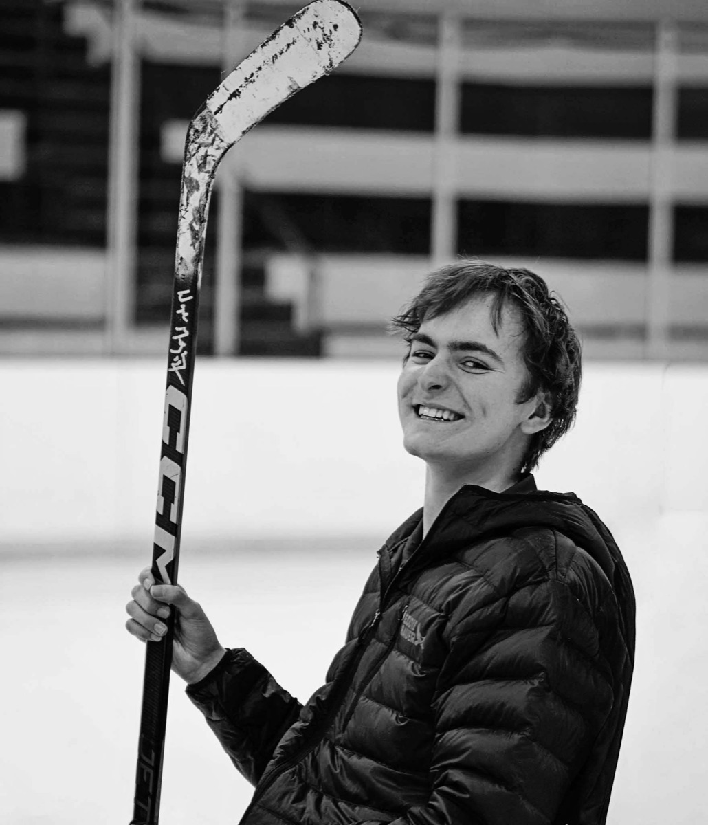 Jackson holding his hockey stick, laughing