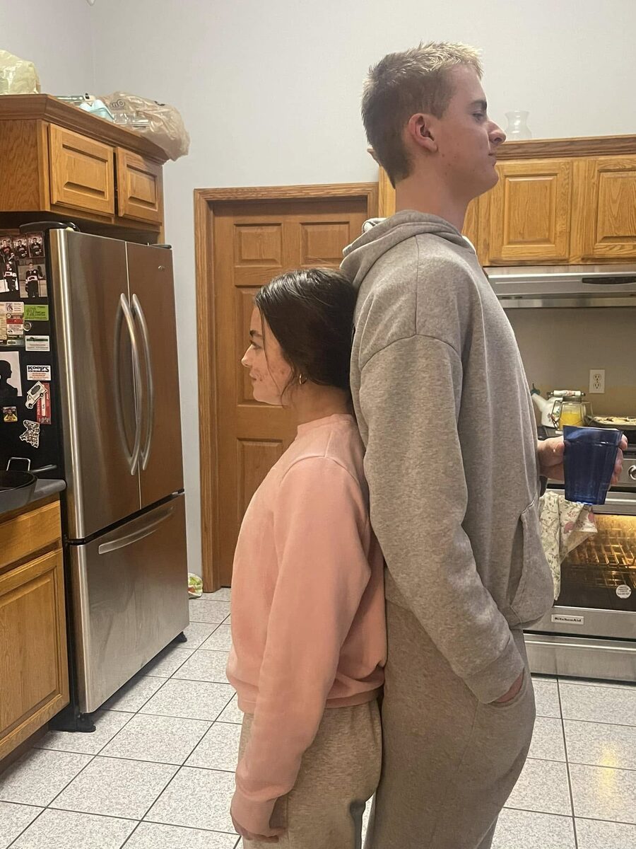 Jackson standing at home with his sister